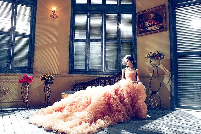 beautiful long wedding dress in a room of many windows